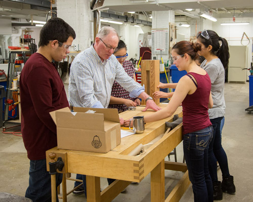 Students and Ken Stone building the wooden printing press